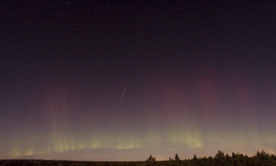 A view of a shooting star Draconid and northern lights near Skekarsbo at the Farnebofjardens national park, 150 km 93 miles north of Stockholm October 8, 2011.