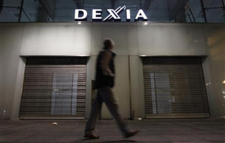 A man walks past the closed entrance of the Belgian-French financial services group Dexia&#039;s headquarters in Brussels