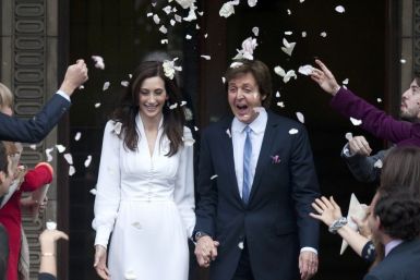 Singer Paul McCartney and his bride Nancy Shevell are showered in confetti as they leave after their marriage ceremony at Old Marylebone Town Hall in London 