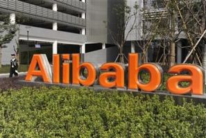 A security guard walks past a logo of Alibaba (China) Technology Co. Ltd at its headquarters on the outskirts of Hangzhou