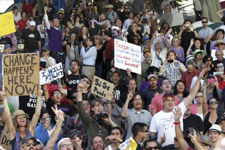 Occupy LA demonstrators cheer on the lawn in front of Los Angeles City Hall