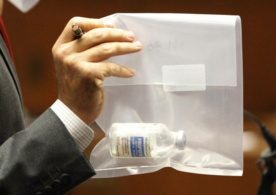 Deputy district attorney David Walgren holds a bottle of propofol found at Michael Jacksons residence during Dr.Conrad Murrays trial in Los Angeles