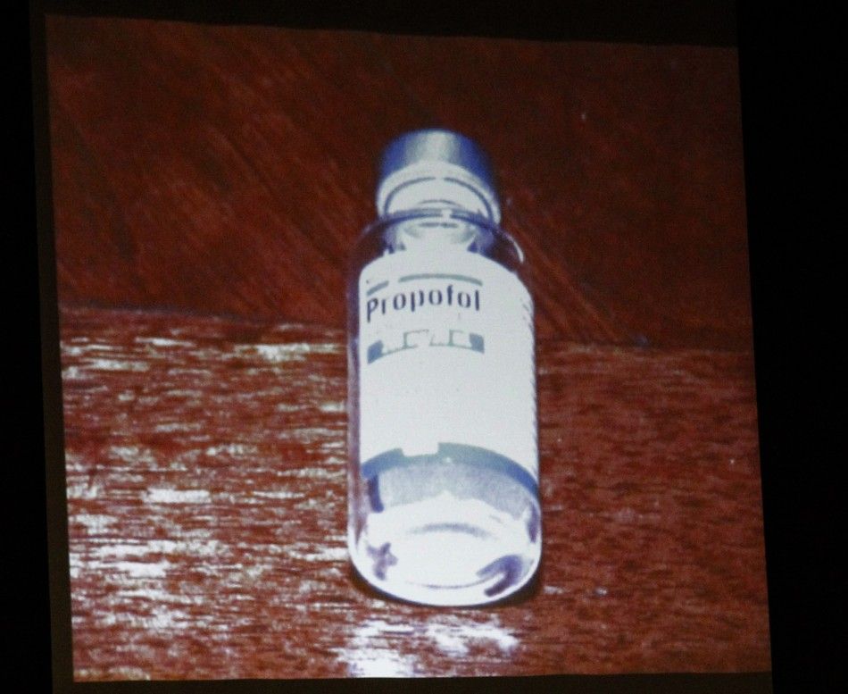 A bottle of propofol lies under a side table found in the bedroom of pop star Michael Jackson in this photo projected on a screen during Dr. Conrad Murrays trial