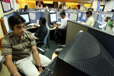 INDIAN EMPLOYEES AT CALL CENTRE PROVIDE INTERNATIONAL CUSTOMER SUPPORT IN BANGALORE.