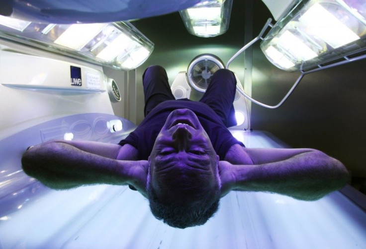 Man in tanning bed.