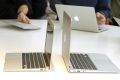 Media and guests check out the latest thinner MacBook Air models after attending a news conference at Apple Inc. headquarters in Cupertino