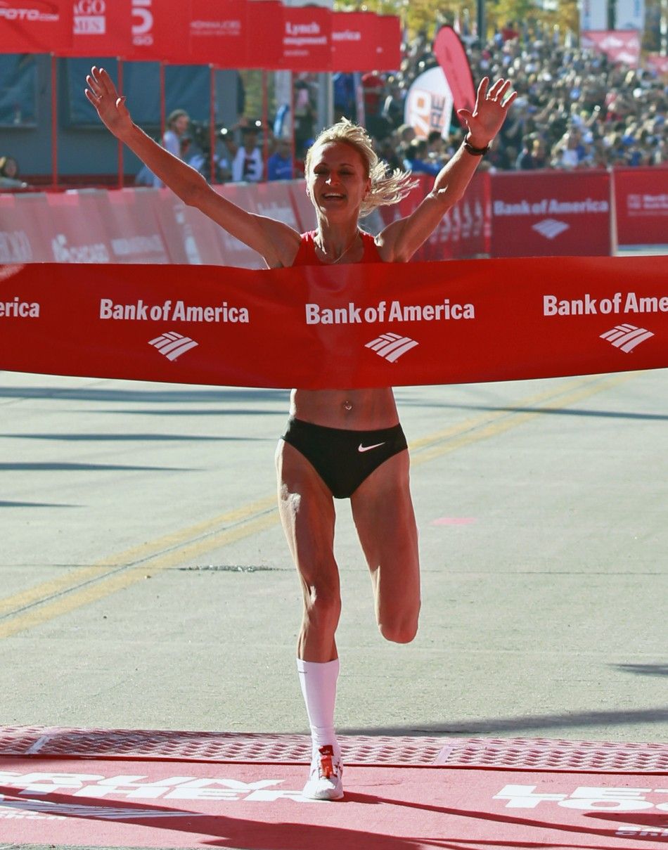 Liliya Shobukhova of Russia celebrates as she wins the Chicago Marathon