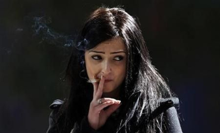 A woman smokes a cigarette outside an office building in central Sydney