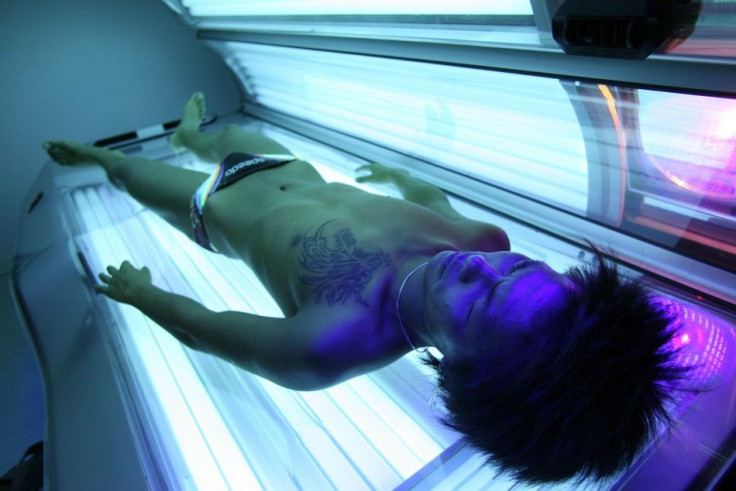 A man lies on a tanning bed during a session in a tanning salon in Shanghai
