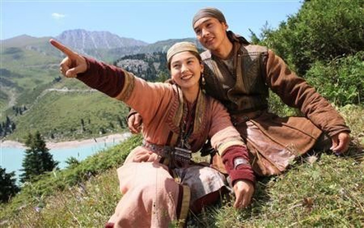 Legendary hero Sartay (R) (Asylkhan Tolepov) sits with his beloved Zere (Aliya Telebarisova) near the Big Almaty Lake in the Tian Shan Mountains where the film Myn Bala was shot in this June 2011