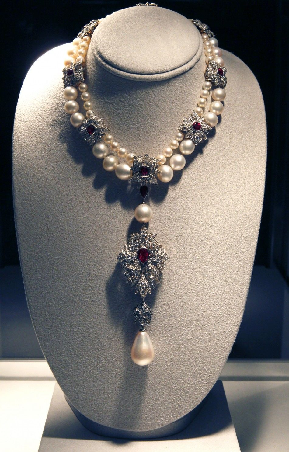 A ruby, diamond and pearl necklace by Cartier with the La Peregrina 60-carat natural pearl pendant is pictured at the press preview for Christies auction of The Collection of Elizabeth Taylor featuring her jewelry, haute couture, fashion, and fine arts a