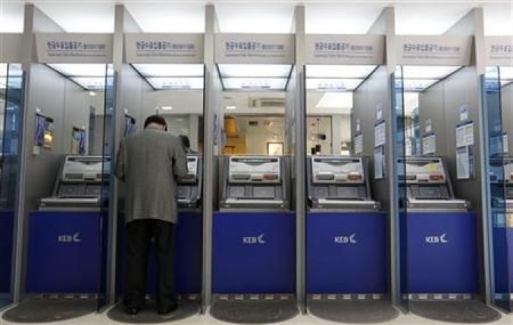 A customer uses an automated teller machine at the headquarters of the Korea Exchange Bank in Seoul
