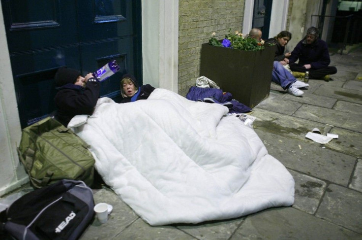 Homeless people sleep rough in the doorway of a church in central London