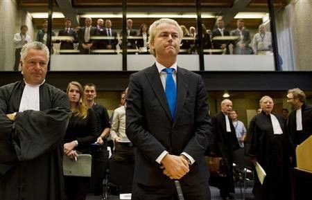 Right-wing Dutch MP Geert Wilders (C) appears in court with his lawyer Mr. Bram Moszkowicz (L) in Amsterdam