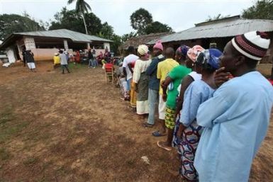 People wait to vote during the presidential election at a polling station in Liberia