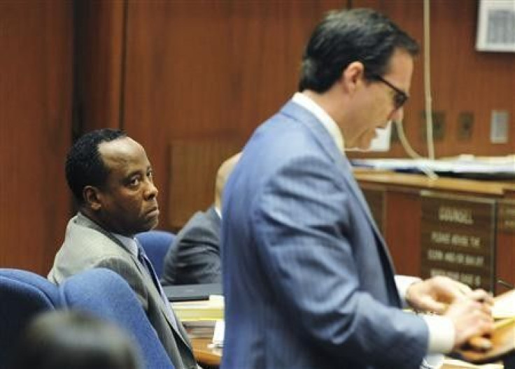 Dr. Conrad Murray listens as his attorney Ed Chernoff question a witness in his trial in the death of pop star Michael Jackson in Los Angeles