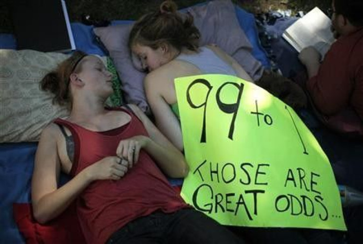 Erin Muhs (L), 23, and Kinsey Diment, 23, rest at the Occupy LA protest camp in Los Angeles, California