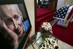 A portrait of assisted-suicide advocate Dr. Jack Kevorkian is seen next to his flag-draped casket following a public memorial at White Chapel cemetery in Troy, Michigan