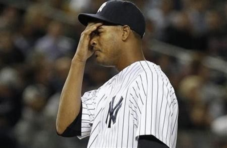 New York Yankees starting pitcher Ivan Nova reacts after giving up a solo home run to Detroit Tigers left fielder Delmon Young in the first inning of Game 5 of their MLB American League Division Series baseball playoffs at Yankee Stadium in New York,
