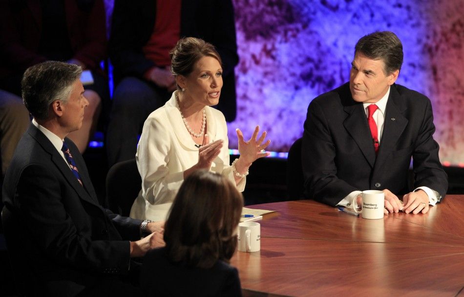 Republican presidential hopefuls L-R former Utah Governor Jon Huntsman, U.S. Rep. Michele Bachmann R-MN, and Texas Gov. Rick Perry participate in a Republican presidential debate at Dartmouth College in Hanover, New Hampshire 