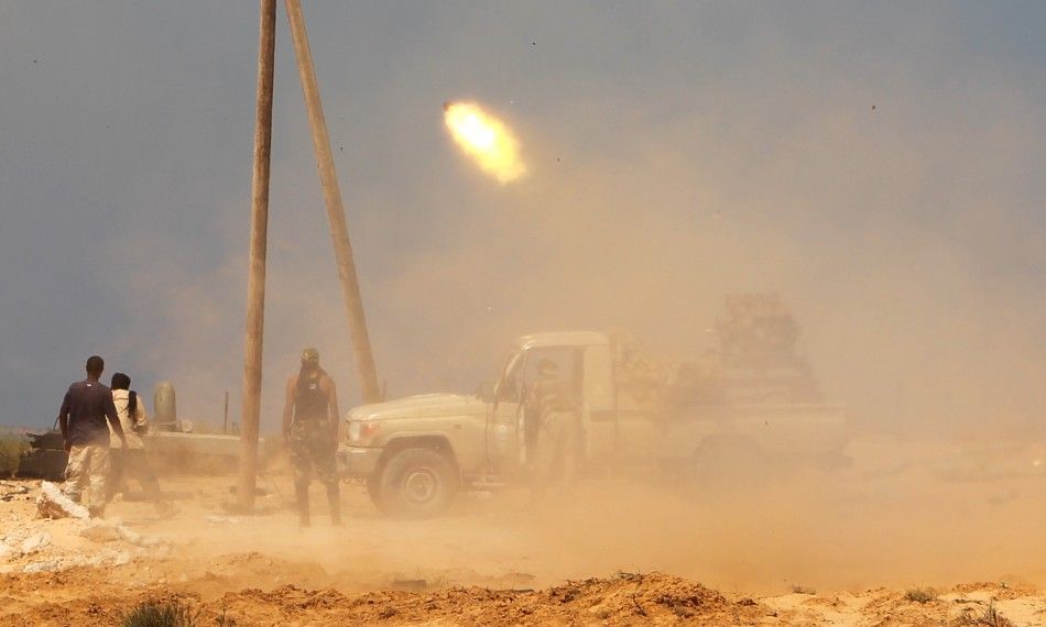 Anti-Gaddafi fighters fire mini-grad missiles towards pro-Gaddafi forces in Sirte city