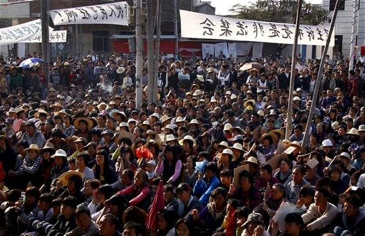 Residents of the village of Wukan in Lufeng county, Guangdong province listen to town representatives speak during a town meeting