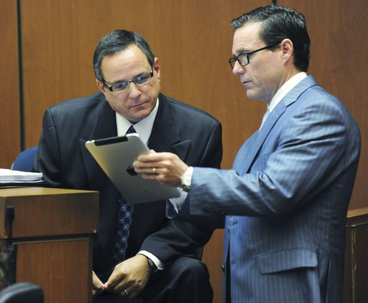 Scott Smith reads notes from Ed Chernoff's iPad during Dr. Conrad Murray's trial in the death of pop star Michael Jackson in Los Angeles