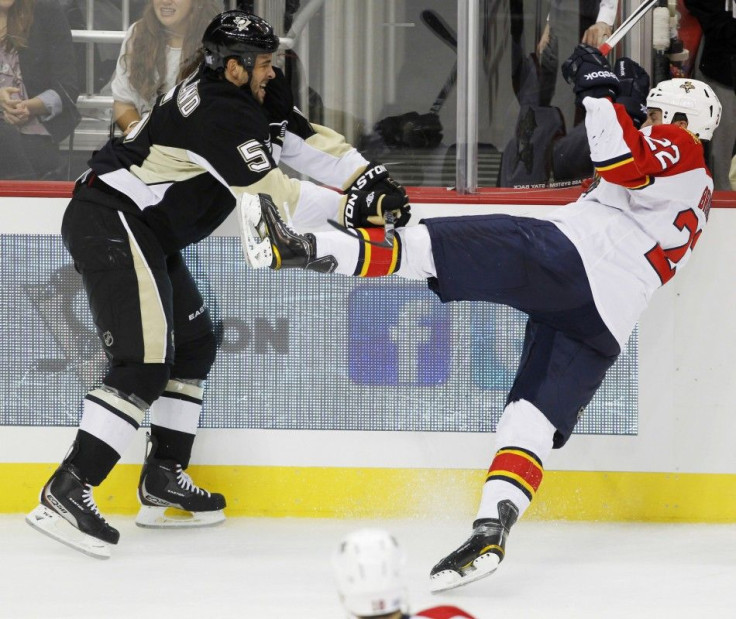 Penguins' Engelland shoves Panthers' Bradley off his skates in the third period of their NHL hockey game in Pittsburgh