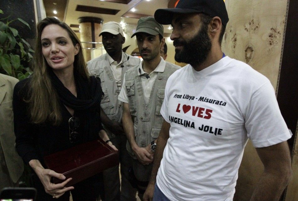 U.S. actress and UN Goodwill Ambassador Angelina Jolie receives a plaque from residents during her visit to the war-torn city October Misrata