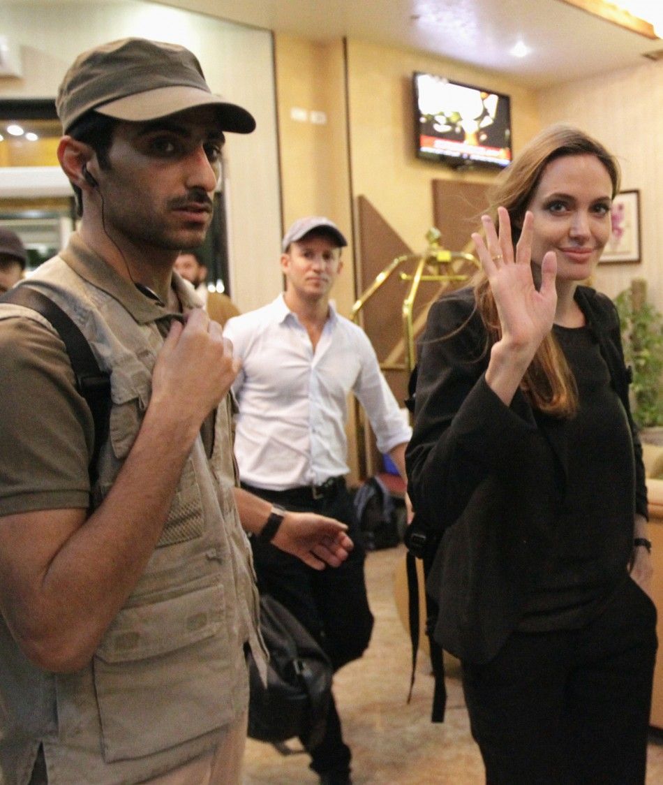 UNHCR Goodwill Ambassador and actress Angelina Jolie waves to the media as she arrives at a hotel during a visit to Misrata