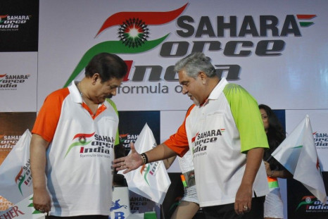 Vijay Mallya, co-owner of the Force India Formula One team, extends his hand to Sahara Group Chairman Subrata Roy at a news conference in New Delhi