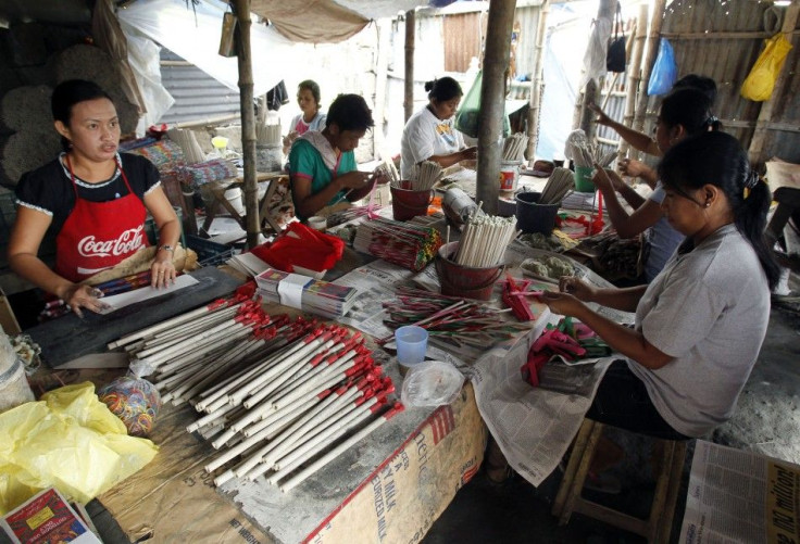 Workers wrap fireworks inside a makeshift factory in Bocaue town at Bulacan province. Phillipines.