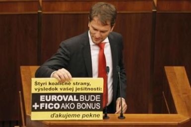 Member of Slovak Parliament Matovic displays a banner during a repeated vote on the euro zone rescue fund, at the Slovak Parliament in Bratislava