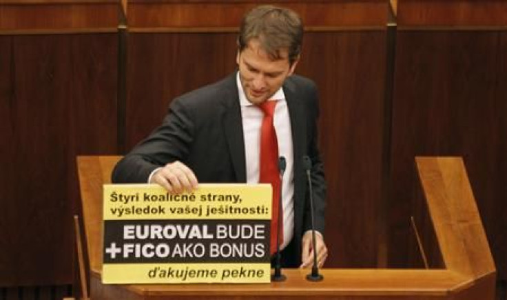 Member of Slovak Parliament Matovic displays a banner during a repeated vote on the euro zone rescue fund, at the Slovak Parliament in Bratislava