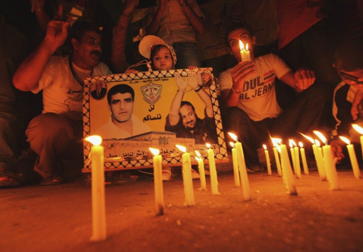 Palestinians light candles as they take part in a rally in solidarity with Palestinian prisoners held in Israeli jails in Gaza