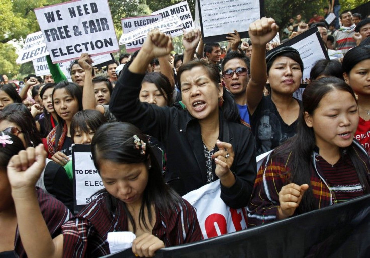 Burmese demonstrators hold a placard and shout slogans during a protest in New Delhi