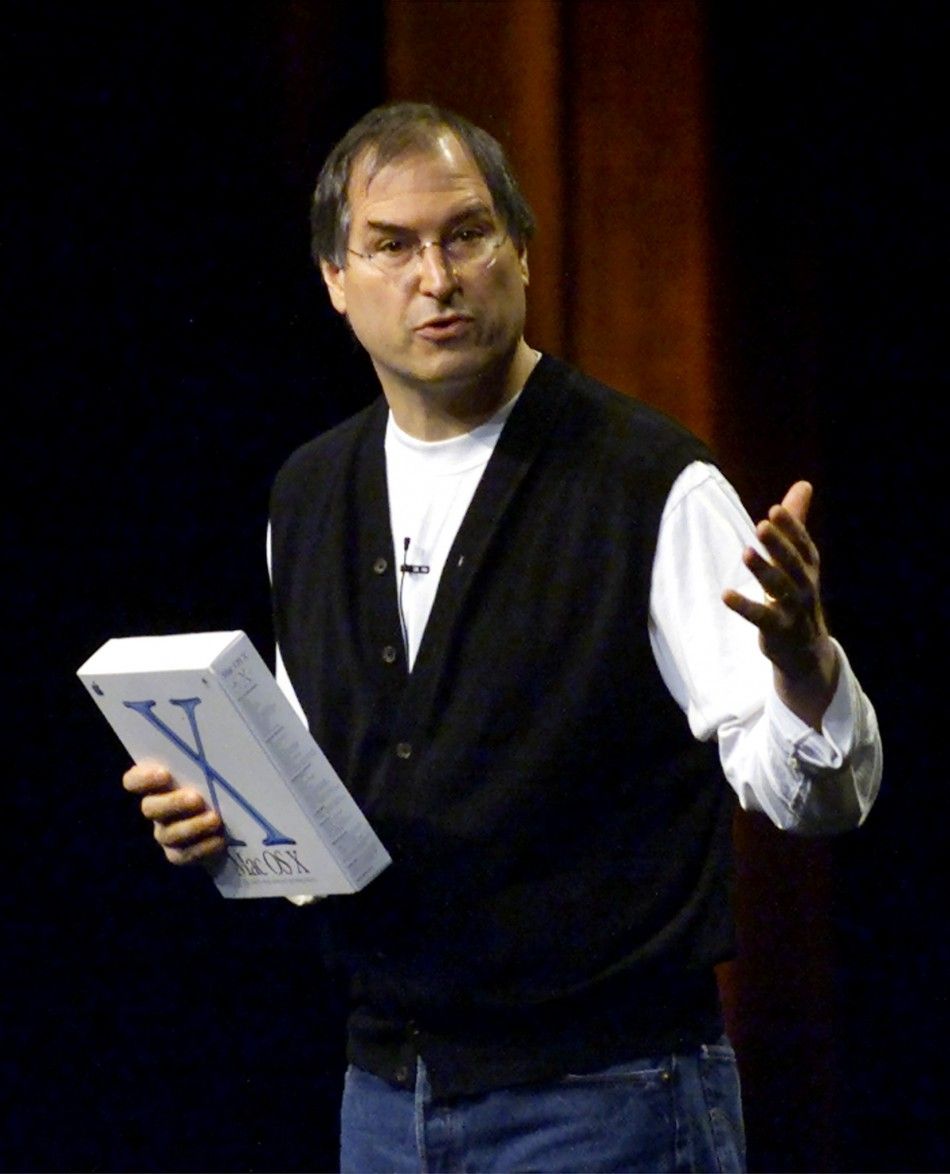 Apple Computer CEO Steve Jobs holds a box containing Apples new Mac OS X operating system while giving the keynote address at the Apple Worldwide Developers Conference in San Jose, California, May 21, 2001