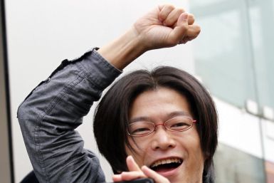 A man reacts as he enters an Apple store to buy iPhone 4S in Tokyo
