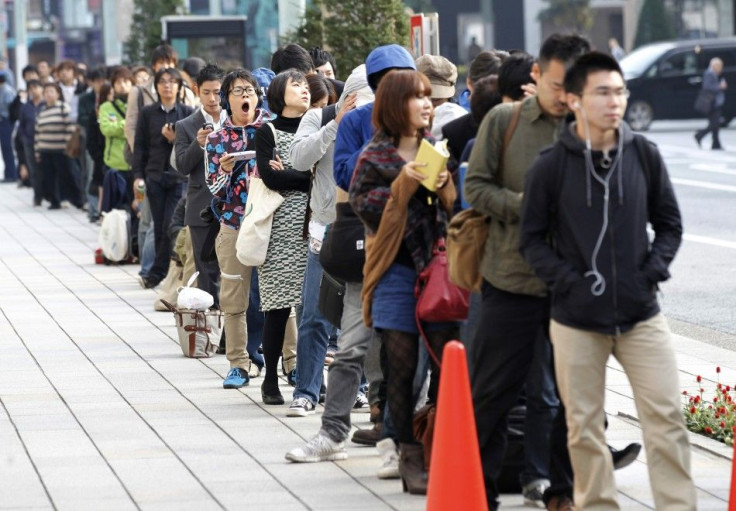 Customers queue to buy iPhone 4S outside an Apple store in Tokyo