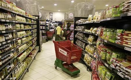 People buy groceries in a supermarket in Zimbabwe"s capital Harare