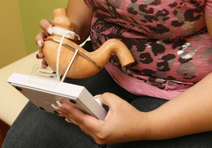 Jazmine Raygoza, 17 looks at a model of a stomach with a Lap-Band attached before her &quot;first fill&quot; at Rose Medical Center in Denver
