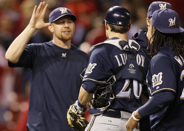 Milwaukee Brewers starting pitcher Randy Wolf celebrates with teammates after picking up his first post season win after defeating the St. Louis Cardinals in Game 4 of the MLB NLCS baseball playoffs in St. Louis