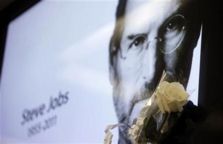 A flower is seen next to a portrait of Apple co-founder and former CEO Steve Jobs at Apple's store in Sao Paulo