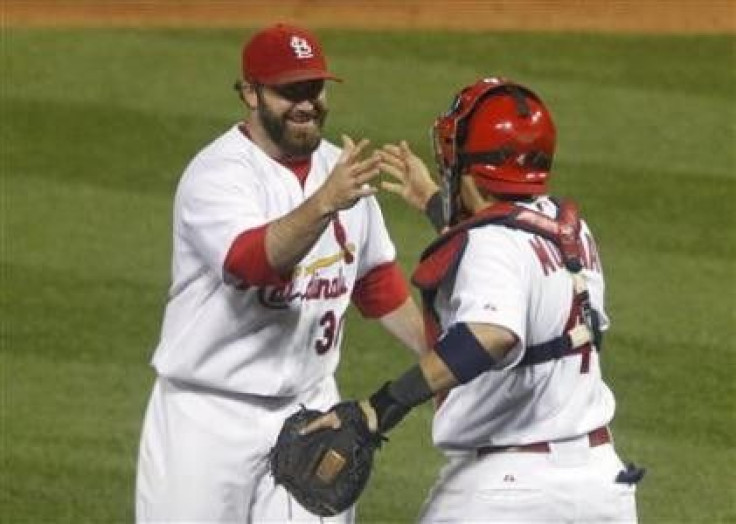 St. Louis Cardinals pitcher Jason Motte (L) and catcher Yadier Molina congratulate each other after beating the Milwaukee Brewers in Game 5 of the MLB NLCS baseball playoff game in St. Louis, Missouri