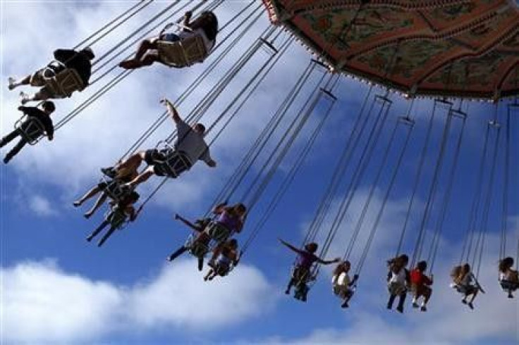 Fairgoers swing through the air on a ride at the San Diego county fair in Del Mar, California
