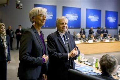IMF chief Lagarde stands with European Central Bank President Trichet at the start of the G20 meeting in Paris