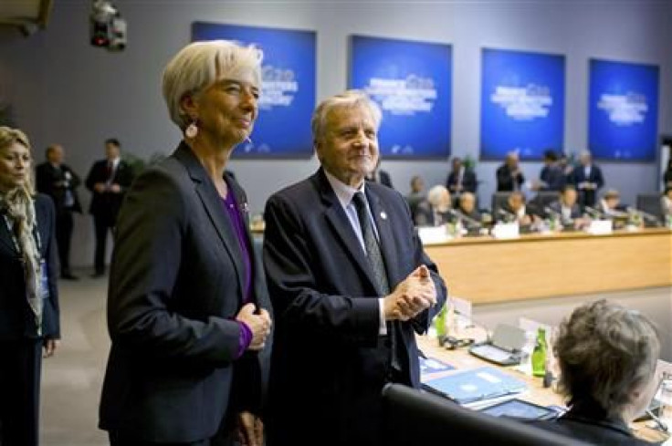 IMF chief Lagarde stands with European Central Bank President Trichet at the start of the G20 meeting in Paris