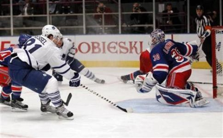 Toronto Maple Leafs' Phil Kessel (L) scores past New York Rangers' goaltender Henrik Lundqvist (R) in the second period of their NHL game in New York, October 15, 2010. 