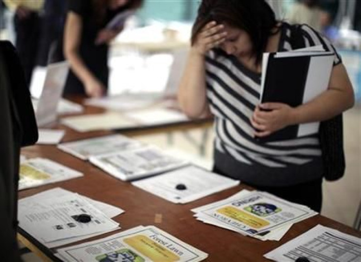 A woman browses job openings at a job fair in Los Angeles