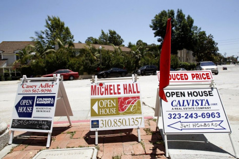 Signs advertising open houses for real estate sale are seen in Los Angeles